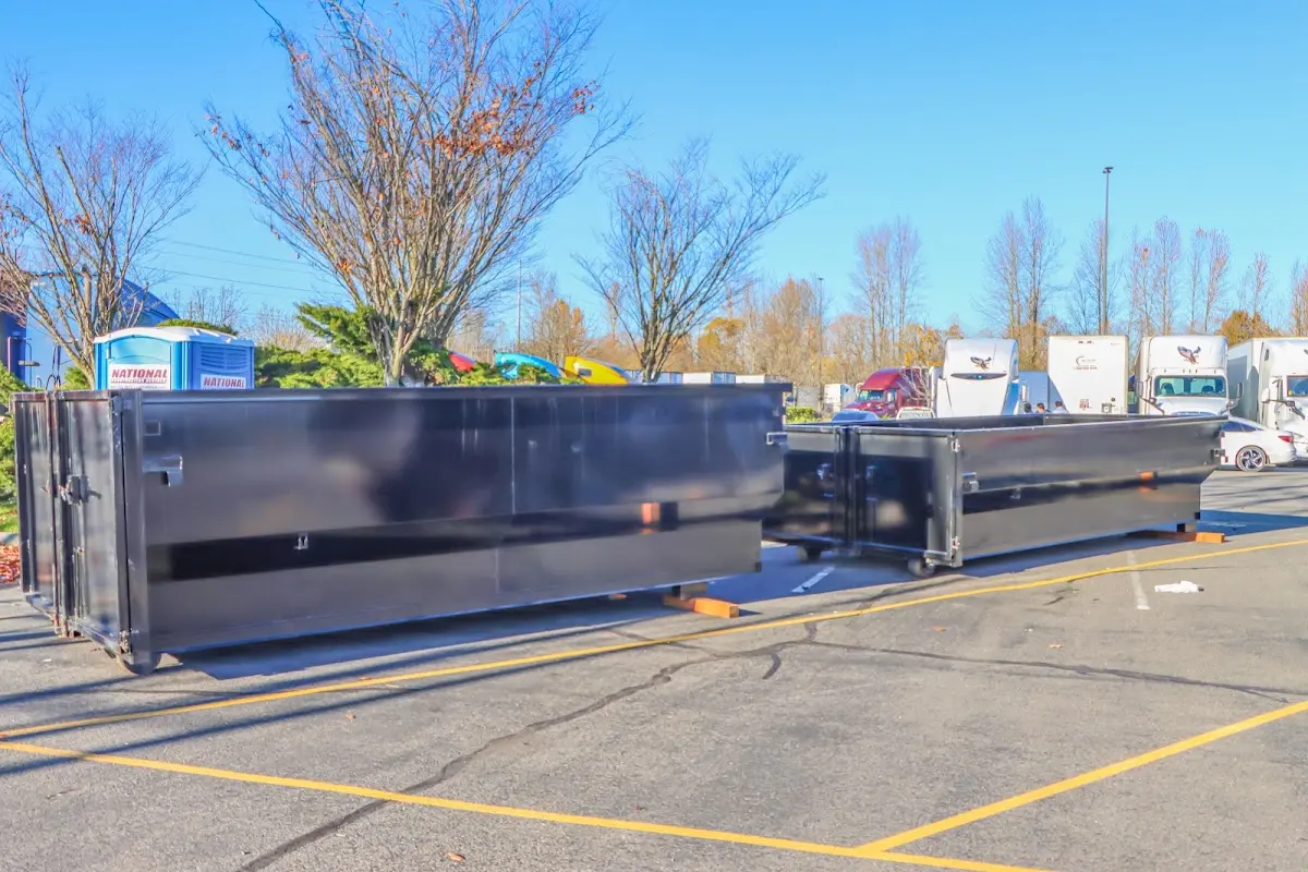 Professional dumpster rental service with roll-off container on residential driveway in Marcellus